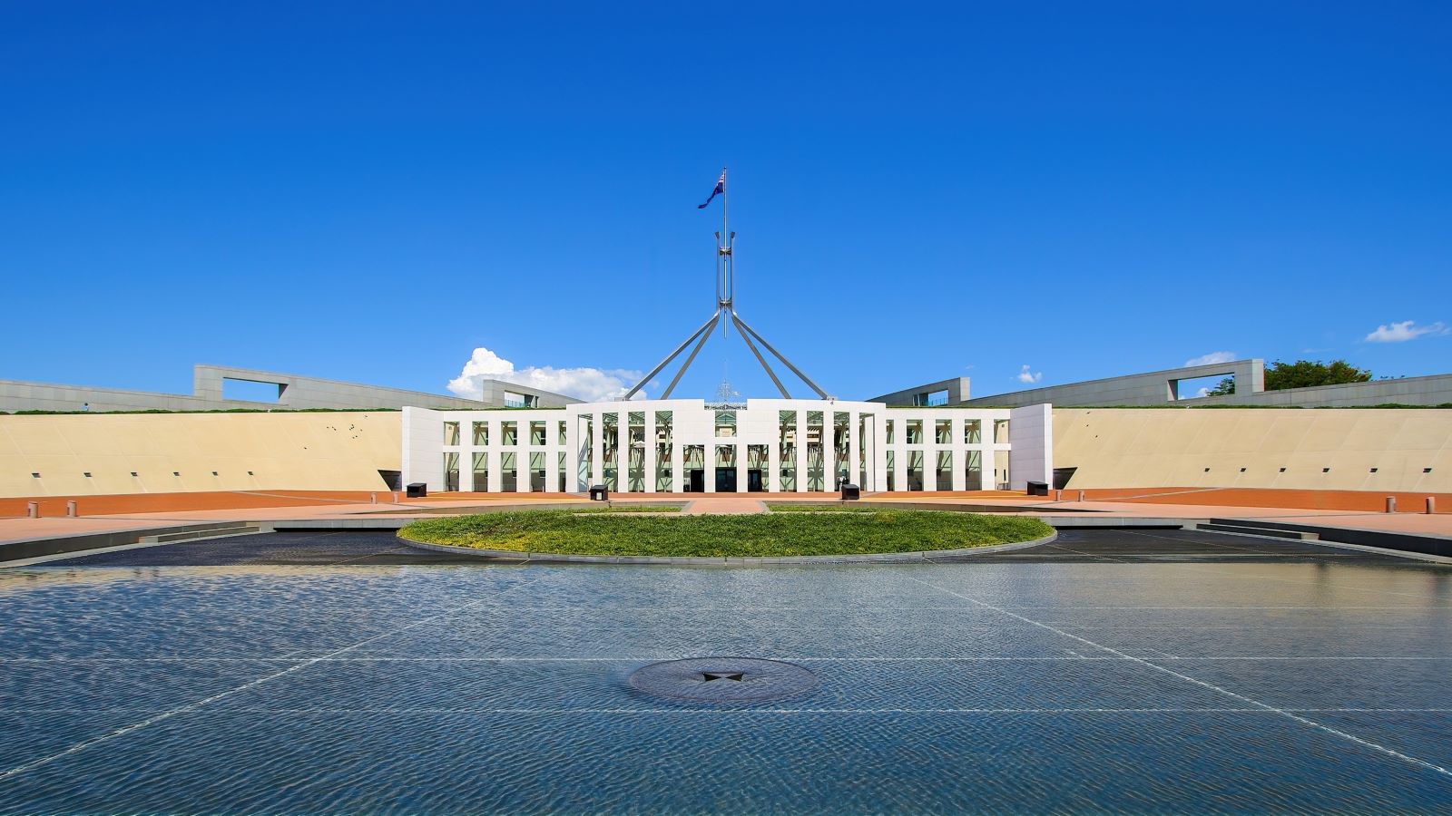 Australian Parliament House, Canberra on a bright day with clear, blue skies.